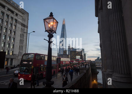 Buses and cars queue on London Bridge during the evening rush-hour, on 8th November 2018, in London, England. Stock Photo