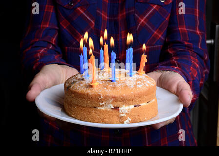 Birthday cake with lit candles Stock Photo