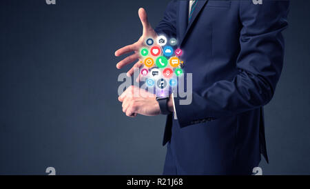 Businessman wearing smartwatch with colored application symbols on it. Stock Photo