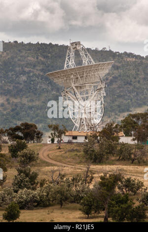 Hobart, Tasmania, Australia - December 13, 2009: Close photo of giant white radio scope at Mount Pleasant Radio Observatory under cloudy sky. Green mo Stock Photo