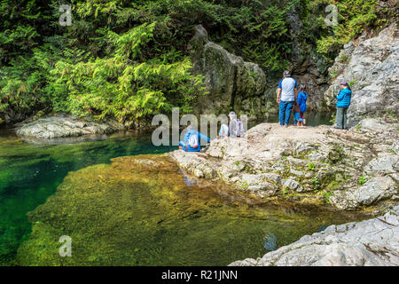 People stand at the 30 Foot Pool in Lynn Canyon Park Vancouver Canada Stock Photo