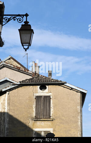 Ornate iron street lamps mounted on buildings in Bourmont, a hill village designated a village of culture, in the Haute-Marne department of France. Stock Photo