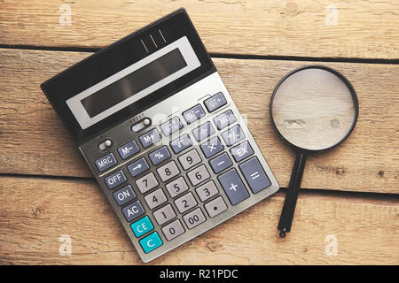The calculator and magnifying glass - objects for economic calculations Stock Photo