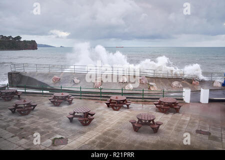 Waves crashing over the sea wall of the English channel at Goodrington Sands, Devon, England. Stock Photo