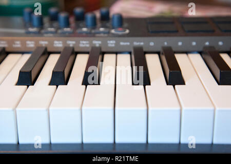 A piano keyboard with dials for creating sounds and music Stock Photo