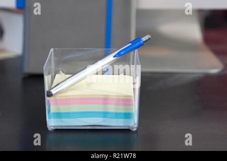 Stack of sticky notes and a pen on a desk Stock Photo