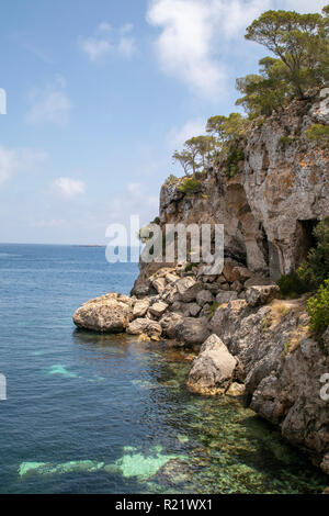 Steep coast, Rocky slopes with trees by the sea at a summerday at Mallorca Stock Photo