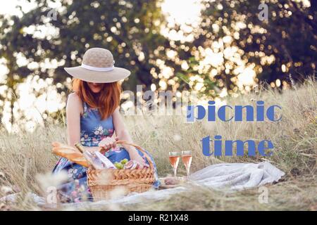 Summer - Provencal picnic in the meadow.  girl smiling girl with a basket on a picnic with the inscription picnic time