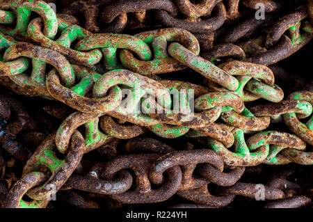 Old rusted  chains with cracked green paint Stock Photo
