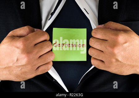 Hiding depression. A man in suit opening and unbuttoning his inner shirt to reveal his depression. Depression is written on a green sticky note. Stock Photo