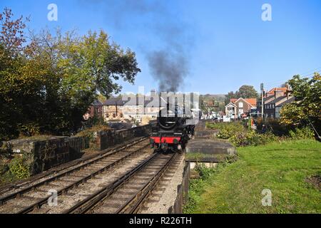 Stanier Black 5 'Eric Treacy' N° 5428 reversing from the sheds towards Grosmont Station in the distance, on a sunny early October morning (NYMR) Stock Photo