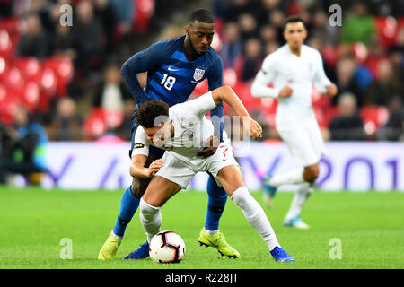 London. United Kingdom. 15th November 2018. England forward Jadon Sancho (7)  under pressure from USA defender Shaq Moore (18)  during the International Friendly match between England and USA at Wembley Stadium. Credit: MI News & Sport /Alamy Live News Stock Photo