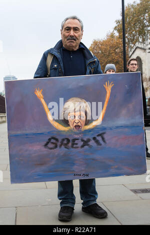 London, UK. 15th November, 2018. Satirical artist Kaya Mar poses with one of his paintings outside the House of Commons following the Cabinet resignations of Brexit Secretary Dominic Raab and Work and Pensions Secretary Esther McVey the day after Prime Minister gained Cabinet approval of a draft of the final Brexit agreement Credit: Mark Kerrison/Alamy Live News Stock Photo