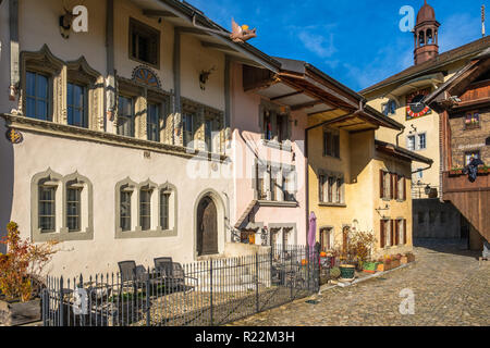 Old medieval road in Gruyeres, Switzerland in autumn light. Stock Photo