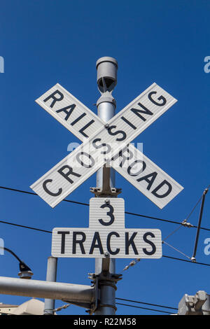 A railroad crossing with three tracks sign in San Diego, California, United States. Stock Photo