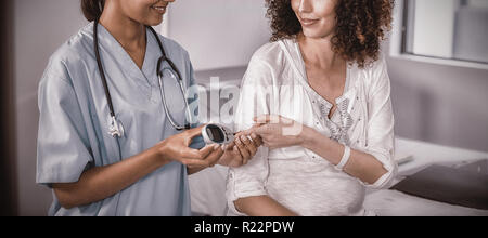 Doctor examining pregnant womans blood sugar Stock Photo