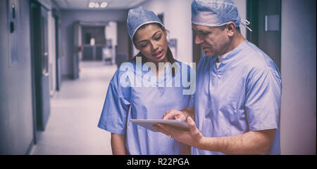 Surgeons discussing over digital tablet Stock Photo
