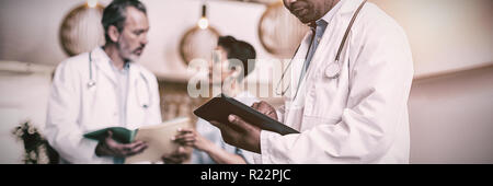 Doctor using digital tablet Stock Photo