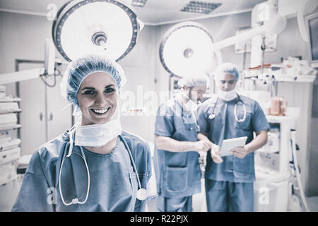 Portrait of smiling female surgeon standing in operation room Stock Photo