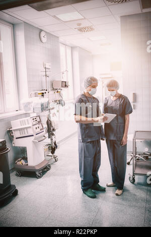 Surgeons discussing over digital tablet Stock Photo