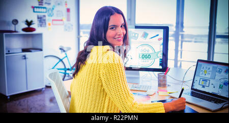 Smiling female graphic designer working in creative office Stock Photo