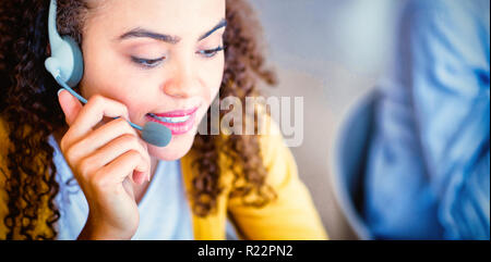 Customer service executive talking on headset Stock Photo