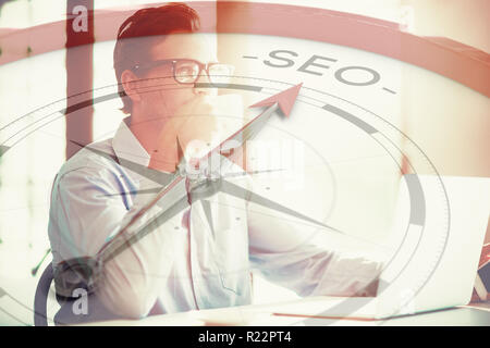 Composite image of compass pointing to seo Stock Photo