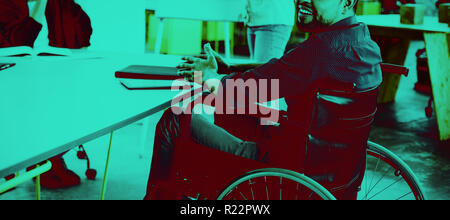 Portrait of smiling disabled business executive in wheelchair at meeting Stock Photo