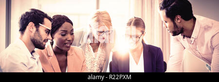 Business people interacting using laptop, mobile phone and digital tablet Stock Photo