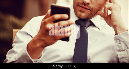 Tensed businessman using mobile phone Stock Photo