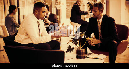 Businessmen having discussion over digital tablet Stock Photo