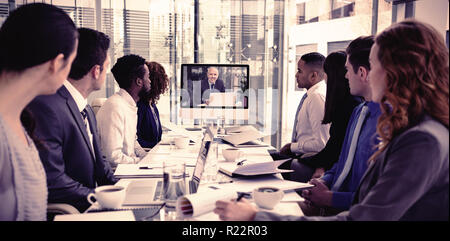 Focused business people looking at screen during video conference Stock Photo