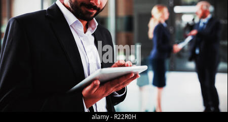 Smart businessman using digital tablet Stock Photo
