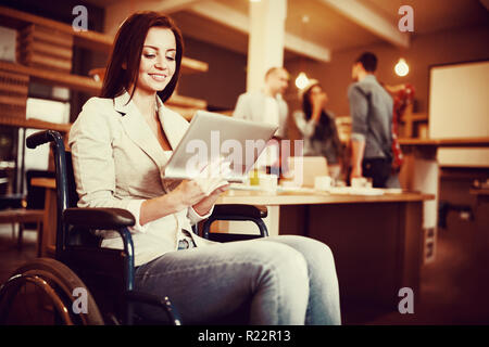 Disabled young businesswoman using digital tablet Stock Photo