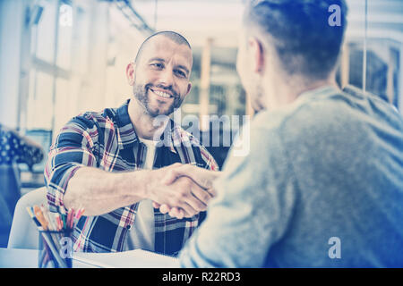 Confident business people shaking hands Stock Photo