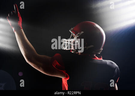 American football player in helmet pointing upwards Stock Photo