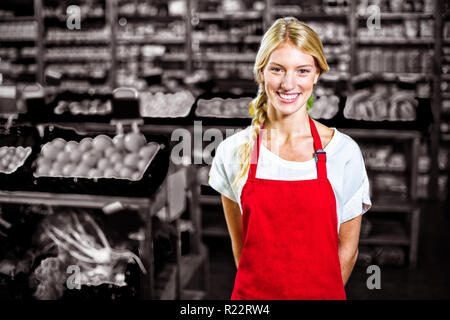 Smiling female staff standing in organic section Stock Photo