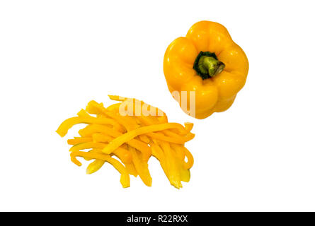 Whole and chopped yellow capsicums isolated on white background Stock Photo