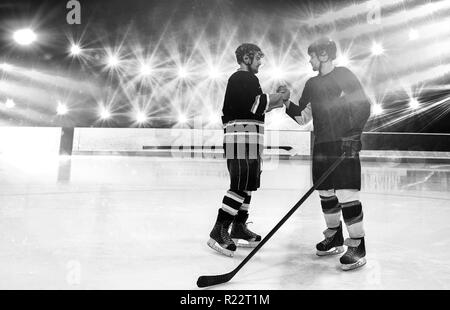 Composite image of ice hockey players shaking hands at rink Stock Photo