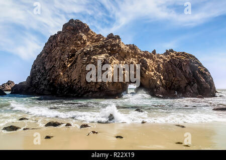 Pacific Ocean waves splash through the iconic Keyhole Arch at Pfeiffer Beach along the Big Sur coast of California. Stock Photo