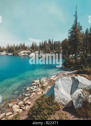 Isolated Crystal Lake in Mammoth Lakes, California, USA with deep blue water and green trees. Stock Photo