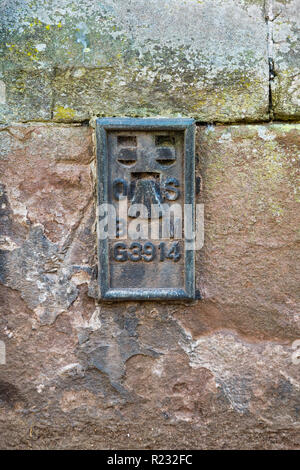 An Ordnance Survey flush bracket, a type of bench mark, on a building in Monmouth. Stock Photo