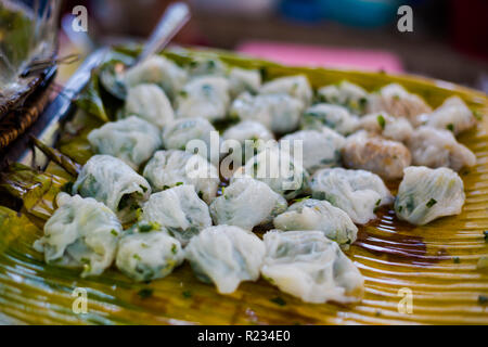 Fresh prepared asian steamed chive rice dimsum dumplings on local market. Traditional thai cuisine made of fresh ingredients. Stock Photo