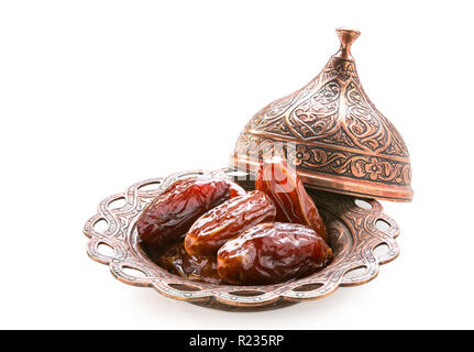 Plate of pitted dates isolated on a white background. Stock Photo