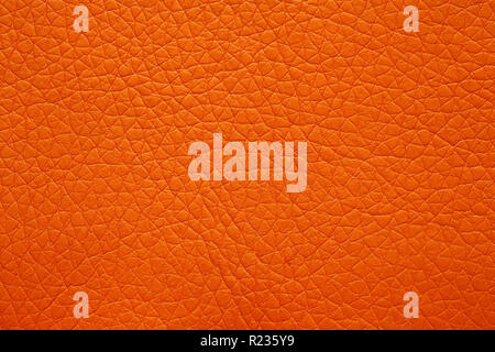 Leatherette texture in magnificent orange colour. Bright orange leather background. Stock Photo