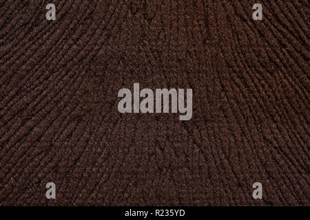 Relief tissue background in dark brown tone. Stock Photo