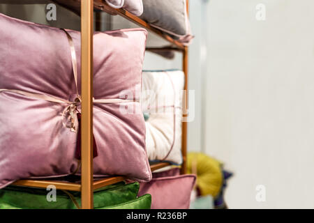 colored decorative pillows on the shelf, background image with  copy space Stock Photo
