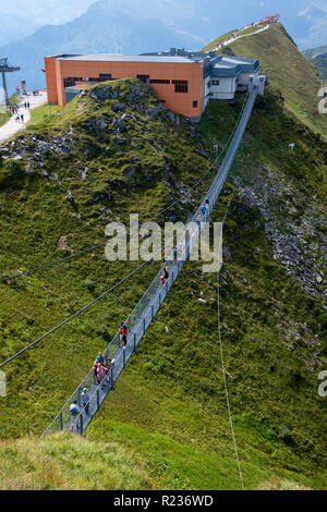 BAD GASTEIN, AUSTRIA - AUGUST 06, 2018: People cross a suspension bridge on the Stubnerkogel, Gastein mountains, Austria, Europe. Stock Photo