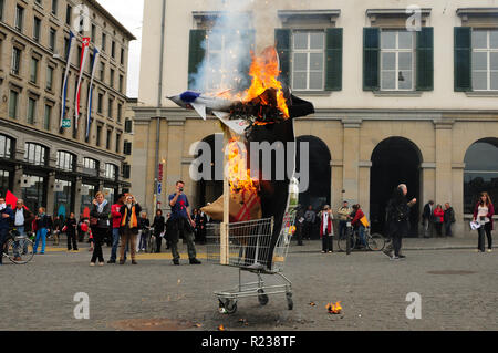 A dummy of the Swiss Federal councillor Ueli Maurer with a burning military jet fighter as a protest for the swiss military aviation armament project Stock Photo