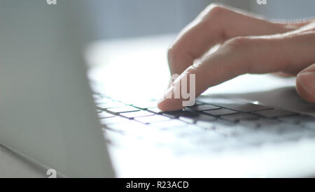 close up. blurred image of male hand typing on laptop keyboard Stock Photo